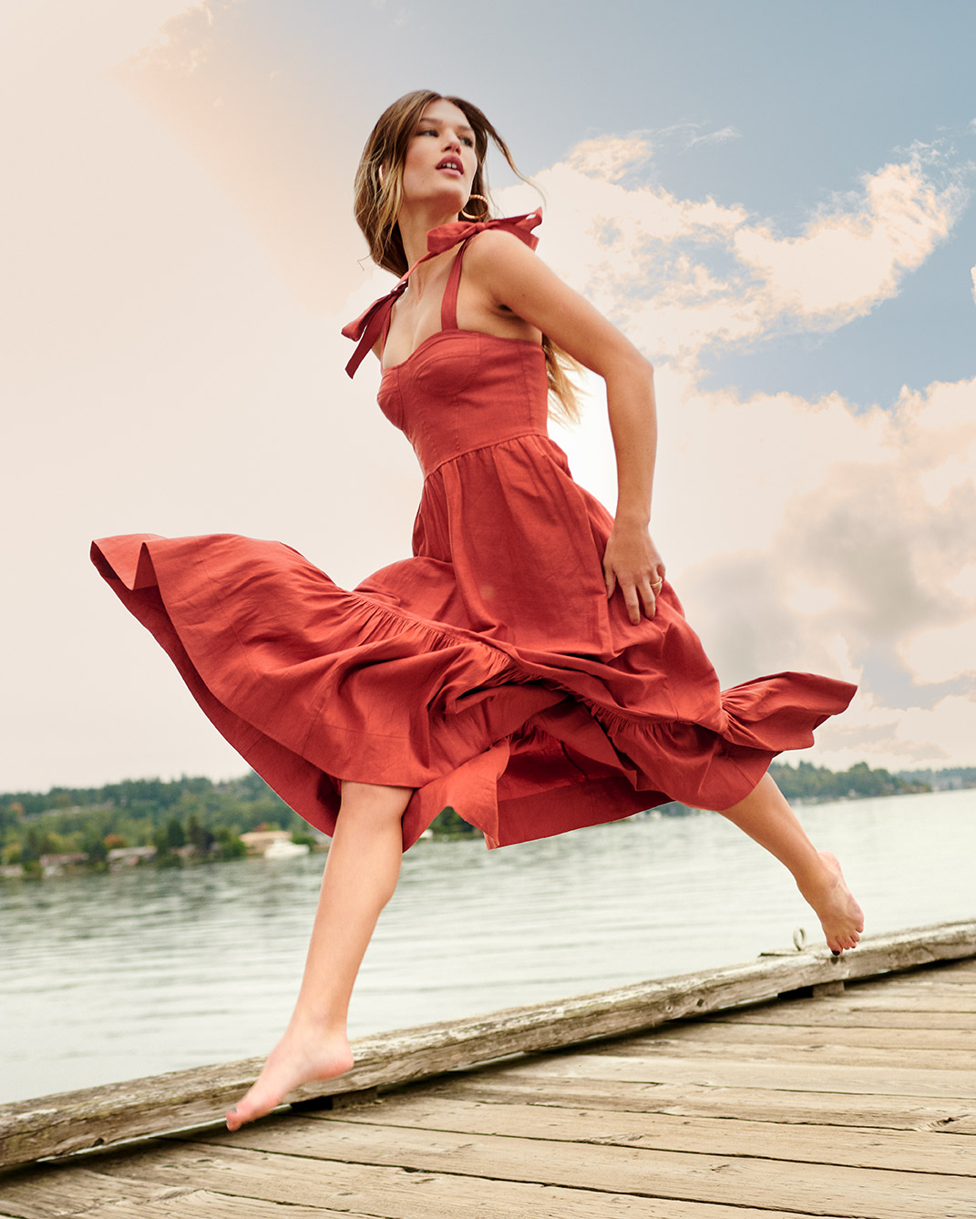 Woman frolicking on dock over lock