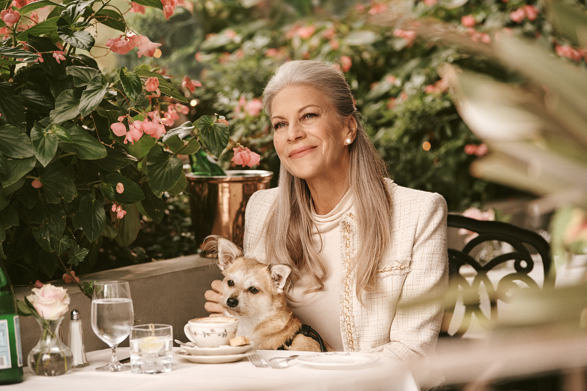 Woman enjoying coffee with dog at Carmine's Restaurant